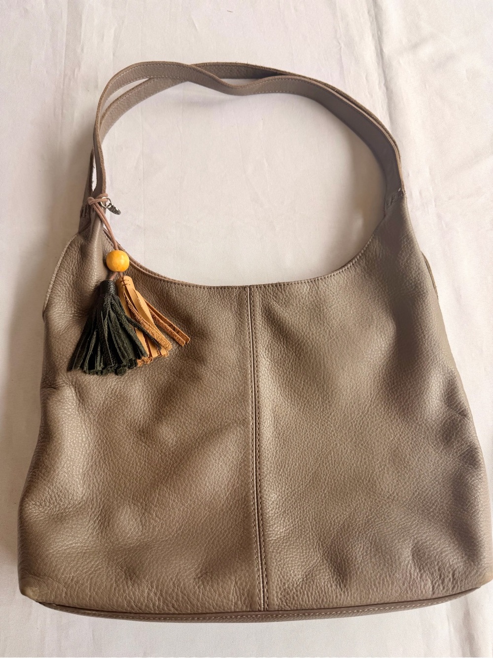 The Sak Huntley Hobo Taupe Leather Shoulder Bag with Decorative Tassel Charm